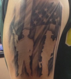 American flag style soldier tattoo on arm