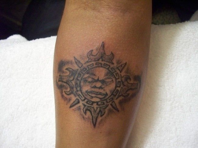 Angry black sun tattoo on arm