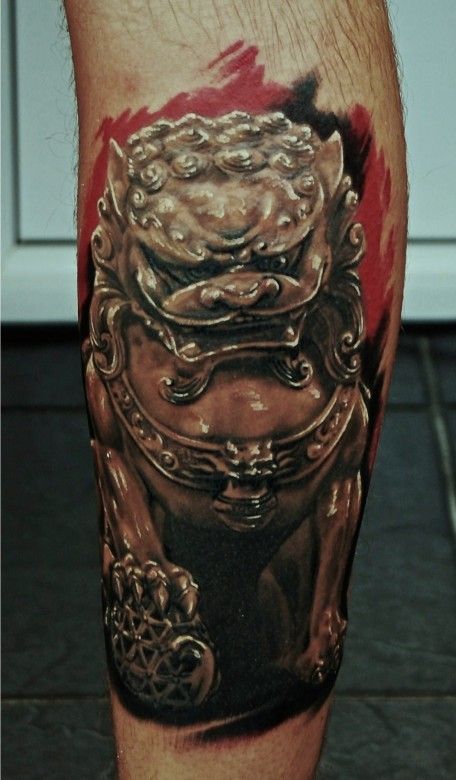 Angry egypt style dog tattoo on leg