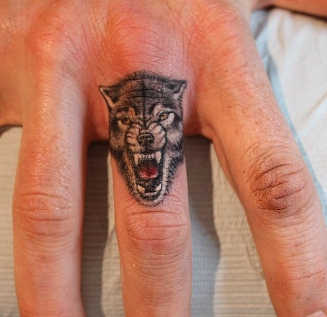 Angry wolf tattoo on finger