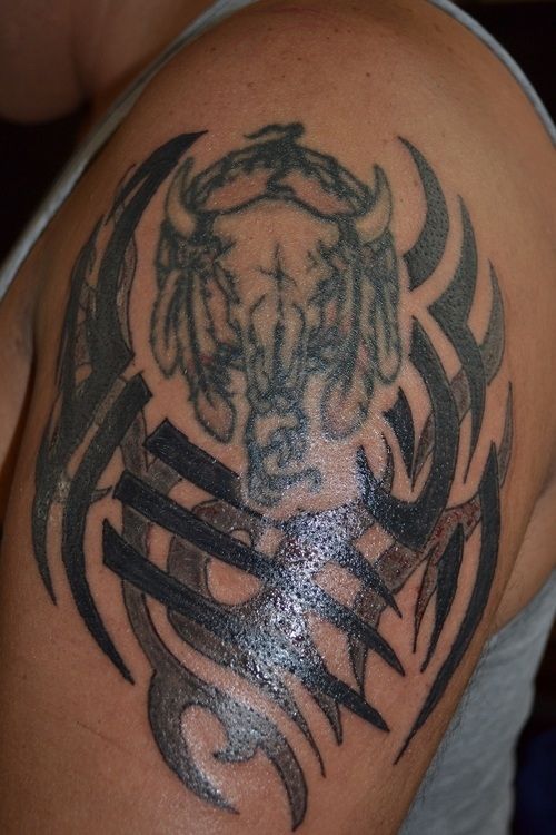 Animal and black tribal tattoo on shoulder