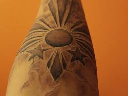 Astonishing black sun tattoo on arm