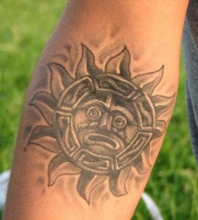 Aztec style sun tattoo on arm