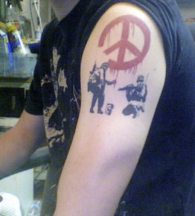 Bansky tattoo on arm