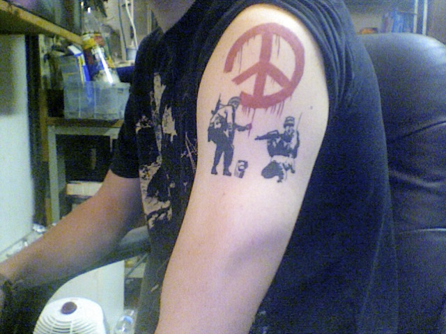 Bansky tattoo on arm