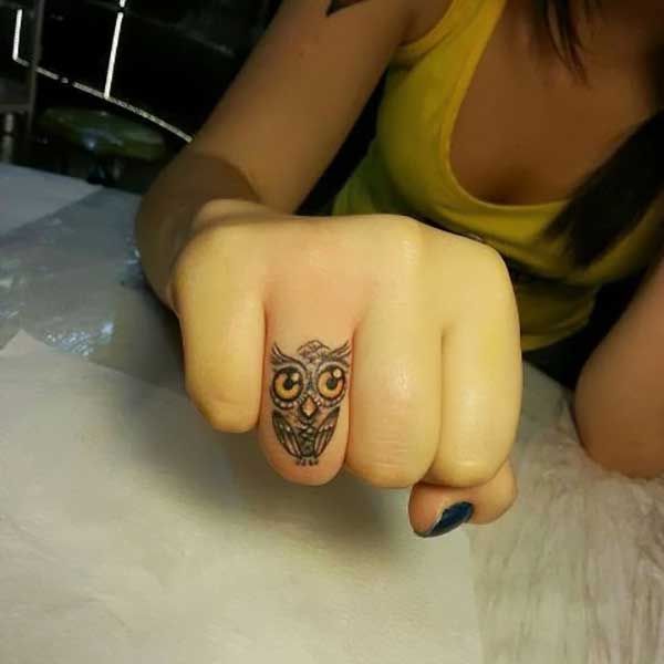 Big eyes owl tattoo on finger