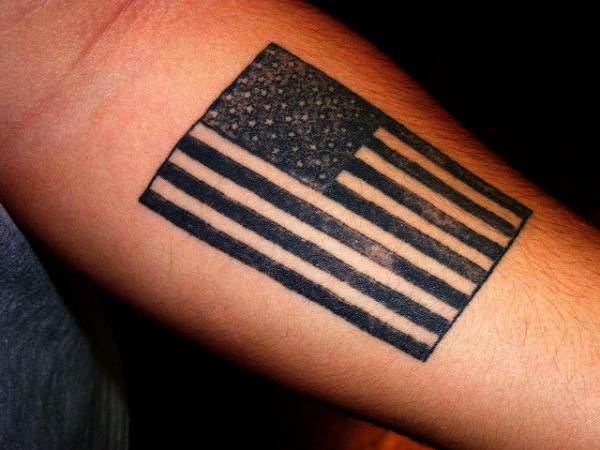 Big tattoo with flag on the hand