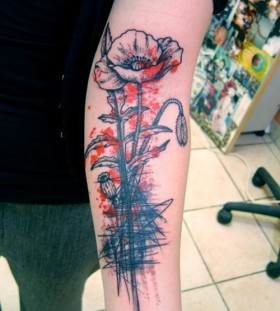 Blac and red poppy tattoo on arm