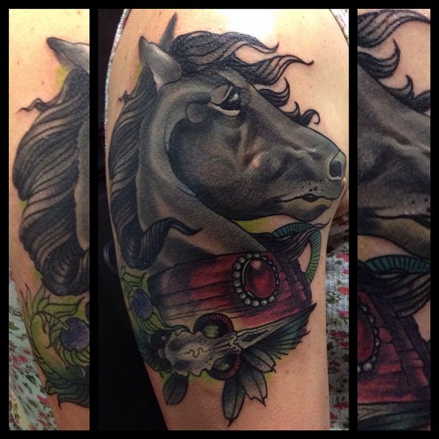 Black adorable horse tattoo on arm