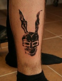Black adorable rabbit tattoo on leg