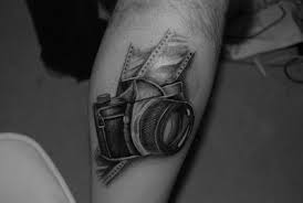 Black amazing camera tattoo on leg