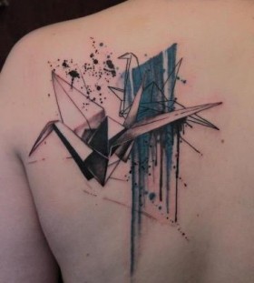 Black and blue origami tattoo on shoulder