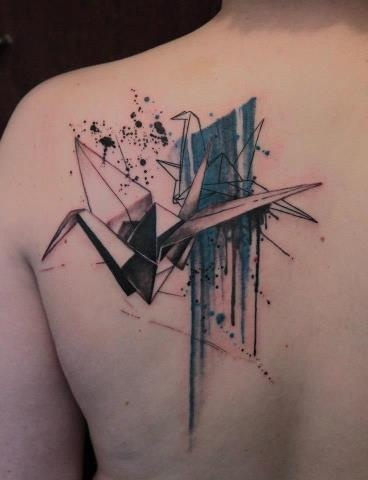 Black and blue origami tattoo on shoulder