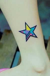 Black and blue star tattoo on leg