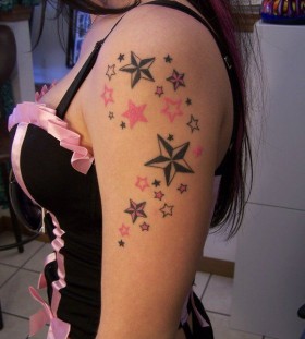 Black and pink star tattoo on arm