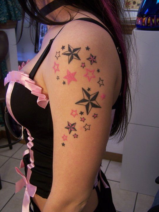 Black and pink star tattoo on arm