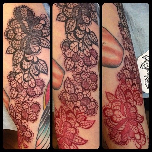 Black and red lace tattoo on arm