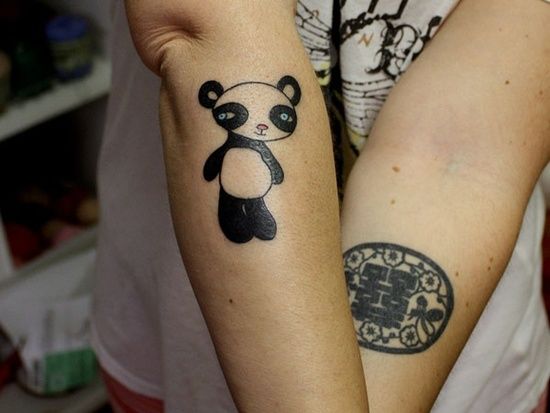 Black and white bear tattoo on arm