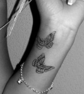Black and white butterfly tattoo on arm