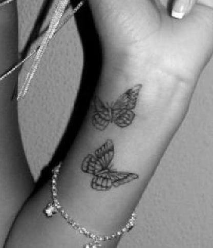 Black and white butterfly tattoo on arm