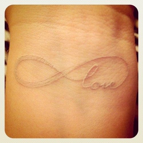 Black and white love tattoo on arm