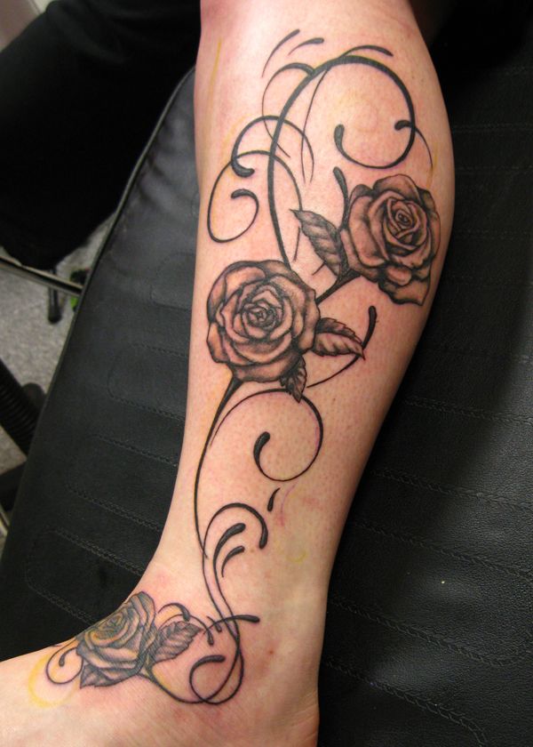 Black and white rose tattoo on leg