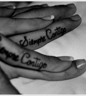 Black and white style quote tattoo on finger