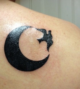 Black bird and black moon tattoo on shoulder