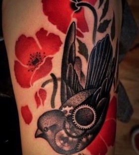 Black bird and poppy tattoo on arm