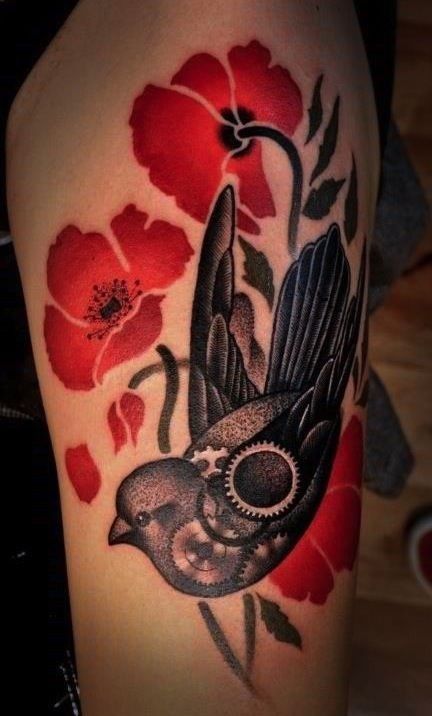 Black bird and poppy tattoo on arm