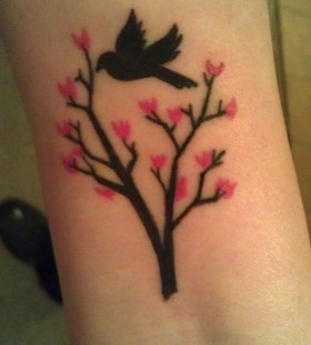 Black bird cherry tattoo on arm
