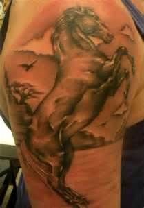 Black birds and horse tattoo on arm