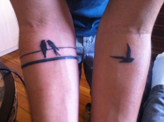Black birds and line tattoo on arm