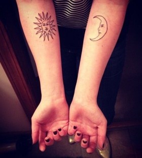 Black conturus of sun tattoo on arm