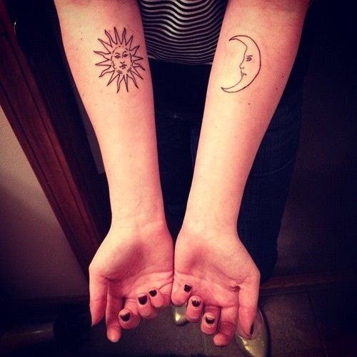 Black conturus of sun tattoo on arm