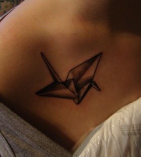 Black crane origami tattoo on shoulder