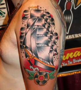 Black cute ship tattoo on arm