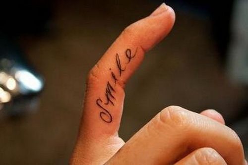 Black cute smile quote tattoo on finger