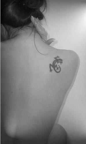 Black dragon tribal tattoo on shoulder