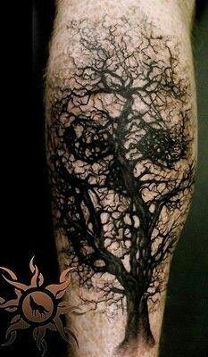 Black eyes and tree tattoo on leg