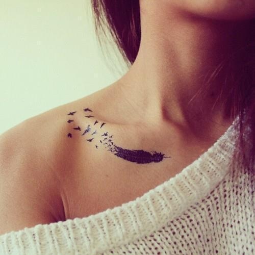 Black feather and bird tattoo on shoulder