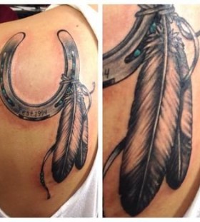 Black feather and horse shoe tattoo