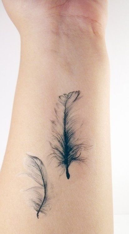 Black feather watercolor tattoo