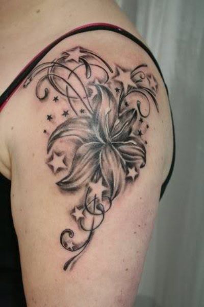 Black flower and star tattoo on arm