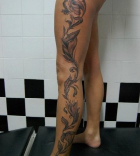 Black flower tattoo on leg