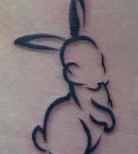 Black funny rabbit tattoo on body