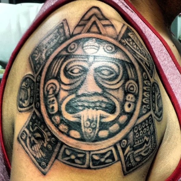 Black great sun tattoo on shoulder