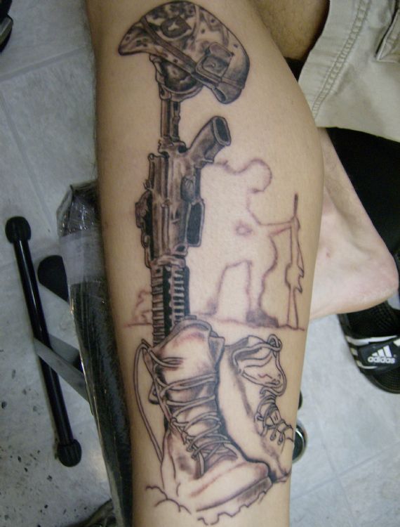 Black gun’s and soldier tattoo on arm