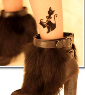 Black high-heels and cute cat tattoo on leg