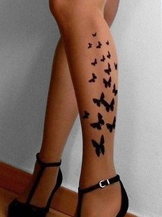 Black left leg butterfly tattoo on leg